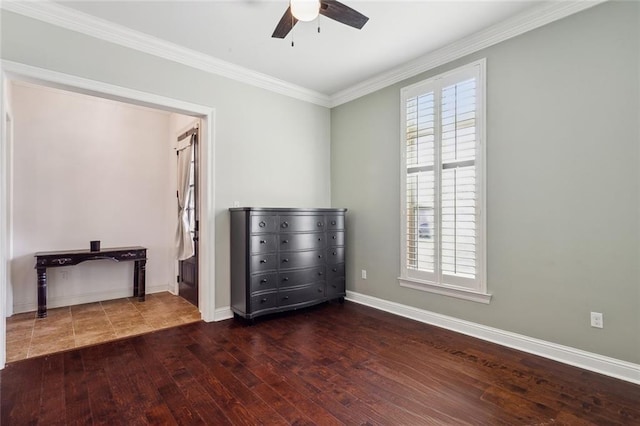 unfurnished bedroom featuring ceiling fan, hardwood / wood-style flooring, baseboards, and ornamental molding