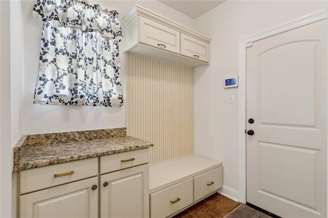 mudroom featuring dark tile patterned floors