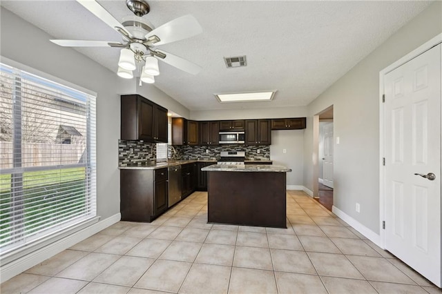 kitchen featuring tasteful backsplash, visible vents, stainless steel appliances, and light tile patterned flooring