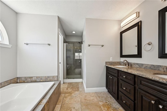 full bathroom featuring a garden tub, double vanity, a stall shower, and a sink