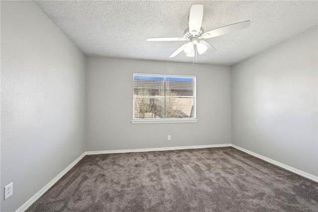 carpeted spare room featuring baseboards, a textured ceiling, and a ceiling fan