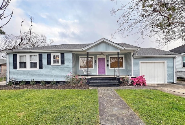 ranch-style home with driveway, a porch, a front yard, an attached garage, and ceiling fan