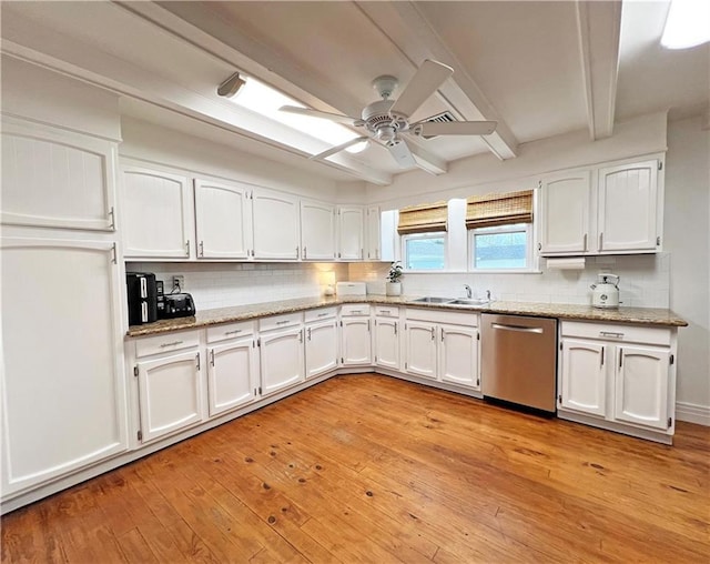 kitchen featuring beam ceiling, a sink, decorative backsplash, white cabinets, and dishwasher