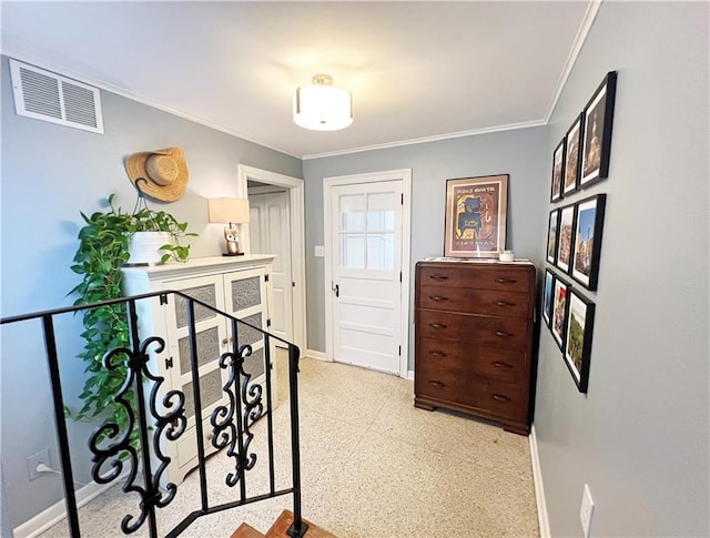 hall featuring visible vents, crown molding, and baseboards