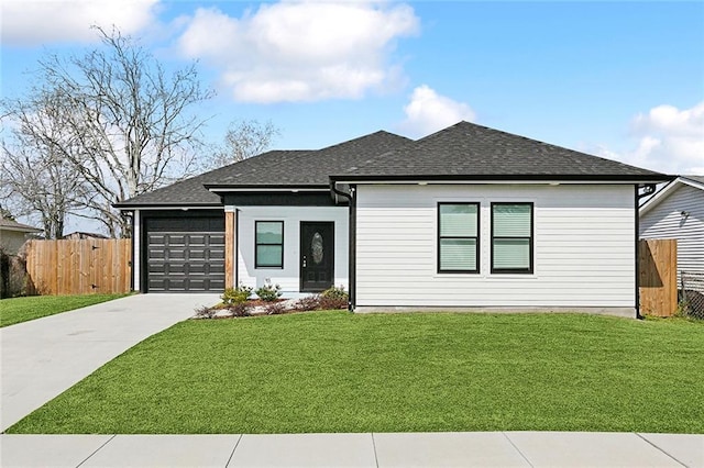 view of front of house featuring a front lawn, driveway, fence, a shingled roof, and a garage