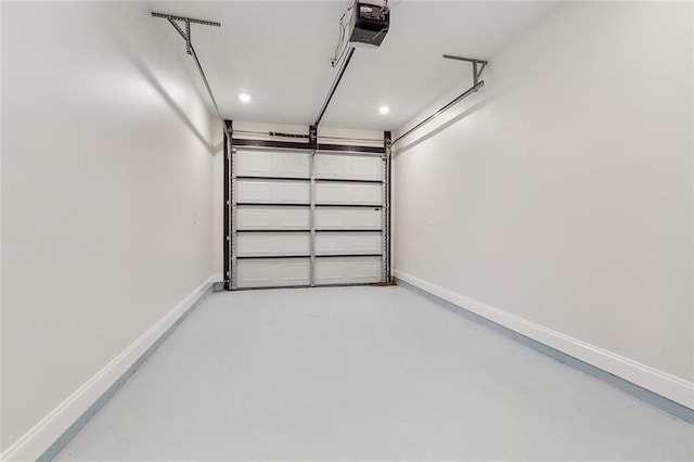 garage with baseboards and a garage door opener