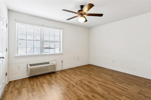 3000 July St Unit 2115, Baton Rouge, LA 70808 - empty room with a wall unit AC, wood finished floors, baseboards, and ceiling fan
