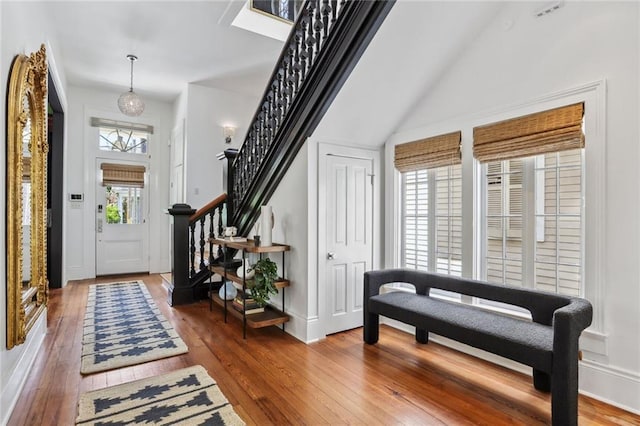 entryway featuring stairway and wood-type flooring