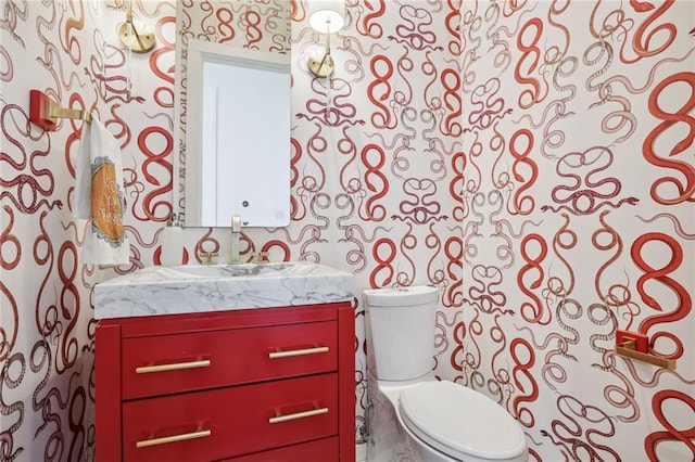 bathroom featuring vanity and toilet