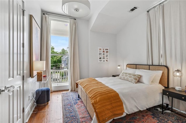 bedroom with visible vents and wood finished floors