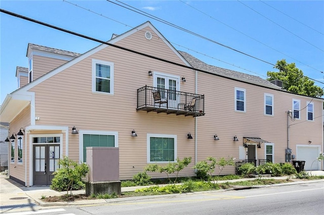 view of front of home featuring french doors and a balcony