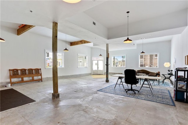 dining room featuring a wealth of natural light and concrete flooring