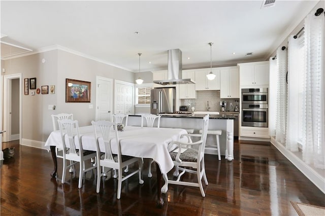 dining room featuring visible vents, baseboards, dark wood-type flooring, and crown molding