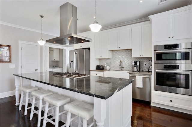 kitchen with backsplash, crown molding, appliances with stainless steel finishes, island range hood, and a sink