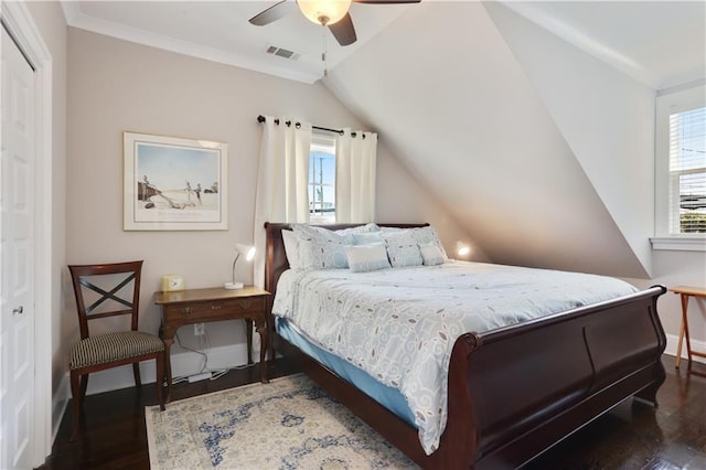 bedroom featuring visible vents, multiple windows, wood finished floors, and ornamental molding