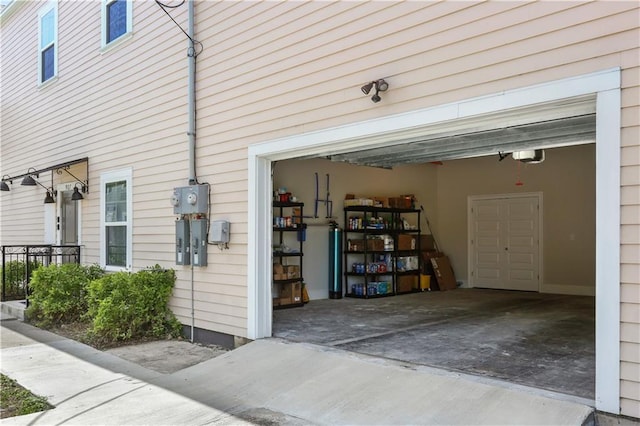 garage featuring driveway and a garage door opener