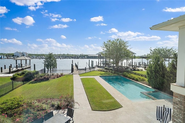 view of swimming pool with boat lift, a lawn, and a dock