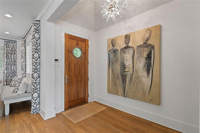 entryway featuring a notable chandelier, recessed lighting, baseboards, and wood finished floors