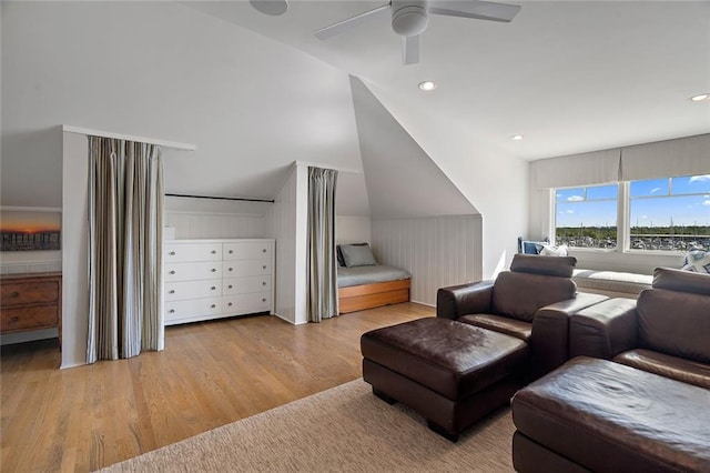 interior space with a ceiling fan, vaulted ceiling, recessed lighting, and wood finished floors