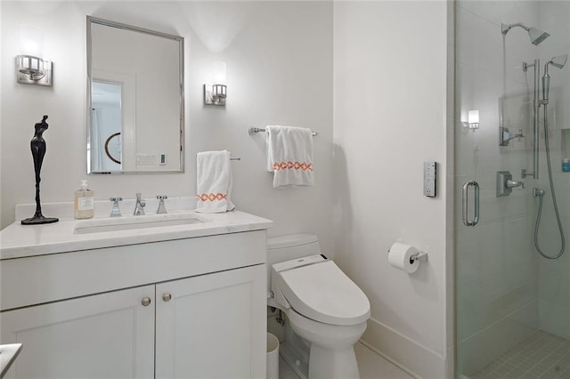 bathroom with a shower stall, toilet, vanity, and baseboards