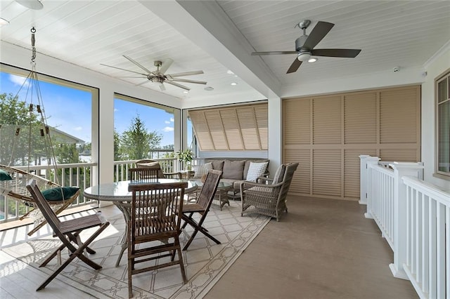 sunroom featuring ceiling fan