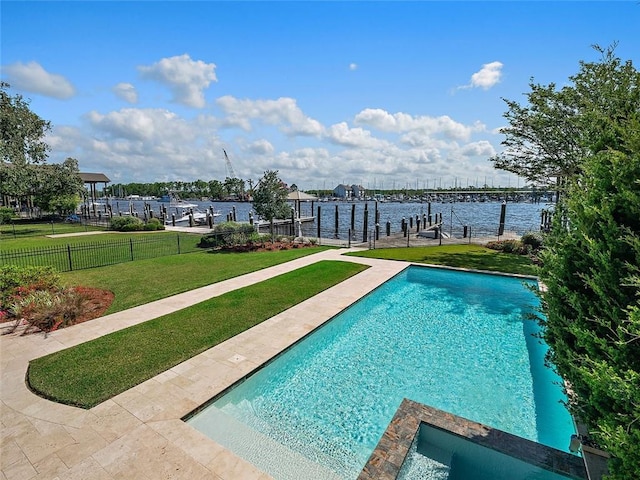 view of pool with a water view, a lawn, a boat dock, a pool with connected hot tub, and fence