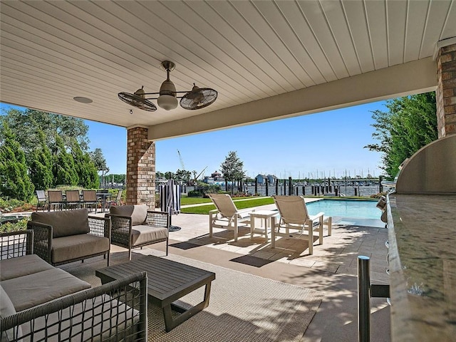 view of patio / terrace with an outdoor pool, outdoor lounge area, and a ceiling fan