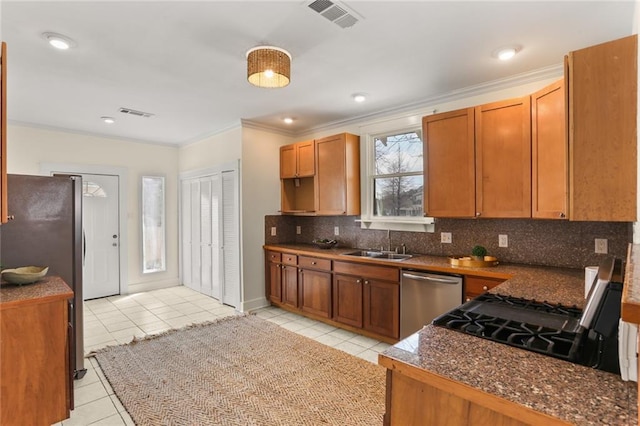 kitchen with visible vents, ornamental molding, tasteful backsplash, appliances with stainless steel finishes, and light tile patterned floors