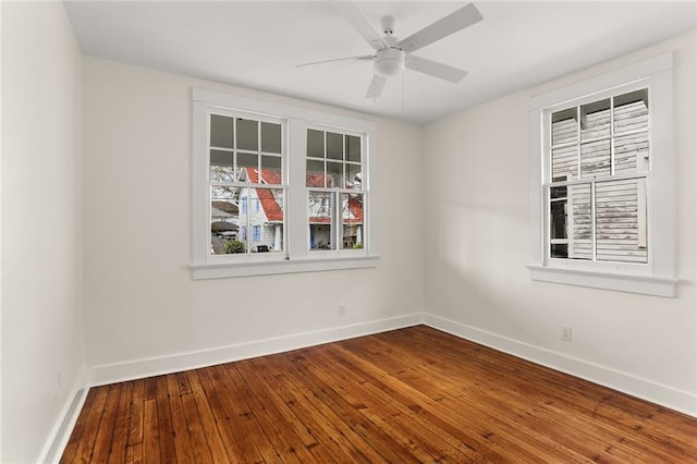 unfurnished room with a ceiling fan, baseboards, and hardwood / wood-style floors