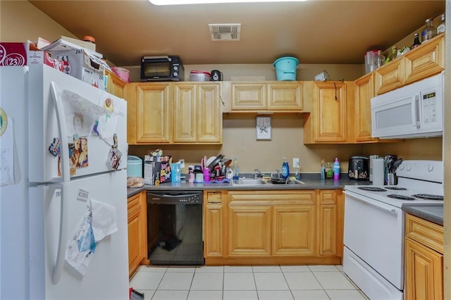 kitchen featuring dark countertops, visible vents, light tile patterned flooring, white appliances, and a sink