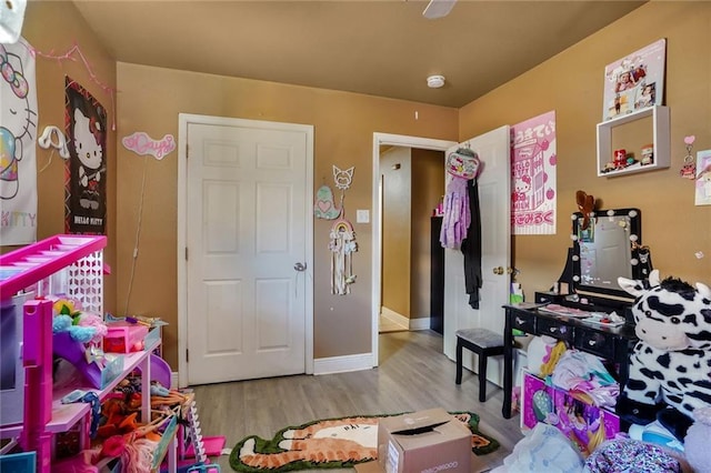 rec room with wood finished floors and baseboards