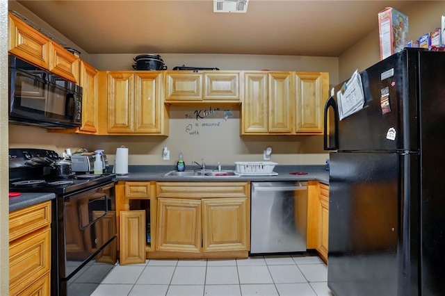 kitchen featuring visible vents, black appliances, a sink, dark countertops, and light tile patterned floors