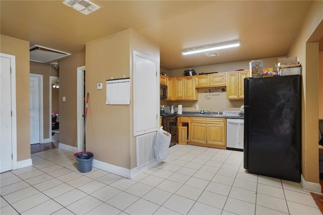 kitchen with a sink, visible vents, black appliances, and light tile patterned floors