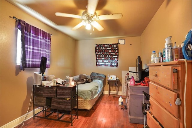 bedroom with baseboards, wood finished floors, and a ceiling fan