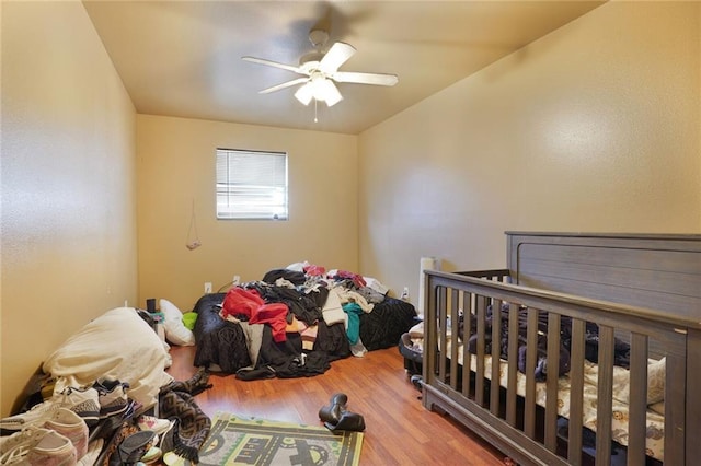 bedroom featuring a ceiling fan and wood finished floors