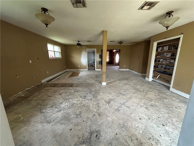 below grade area featuring ceiling fan, visible vents, baseboards, and a baseboard heating unit