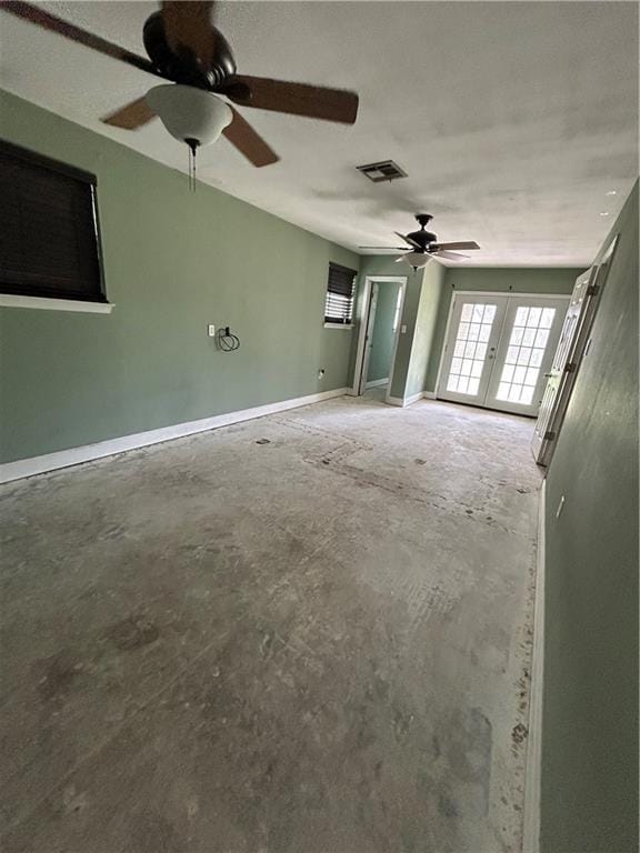 unfurnished living room with visible vents, ceiling fan, unfinished concrete floors, and french doors