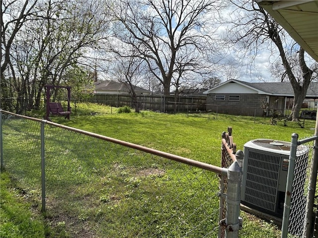 view of yard featuring a fenced backyard and central AC