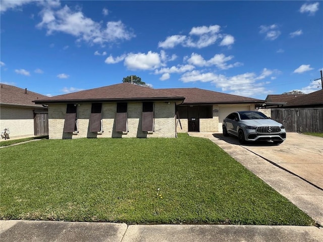 view of front facade featuring driveway, fence, a front yard, an attached garage, and brick siding