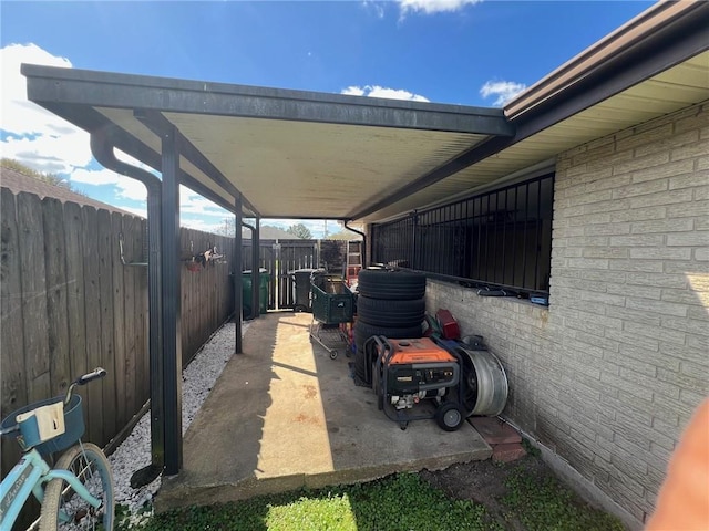 view of patio featuring an outbuilding, an exterior structure, and a carport