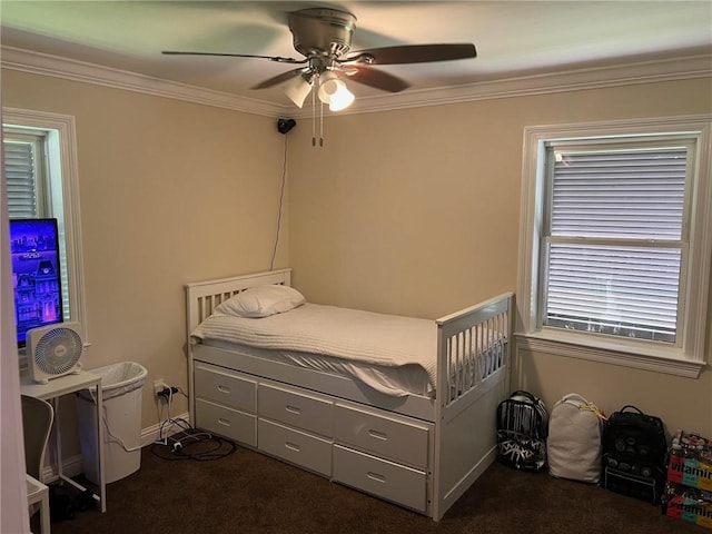 bedroom featuring a ceiling fan, carpet floors, and ornamental molding