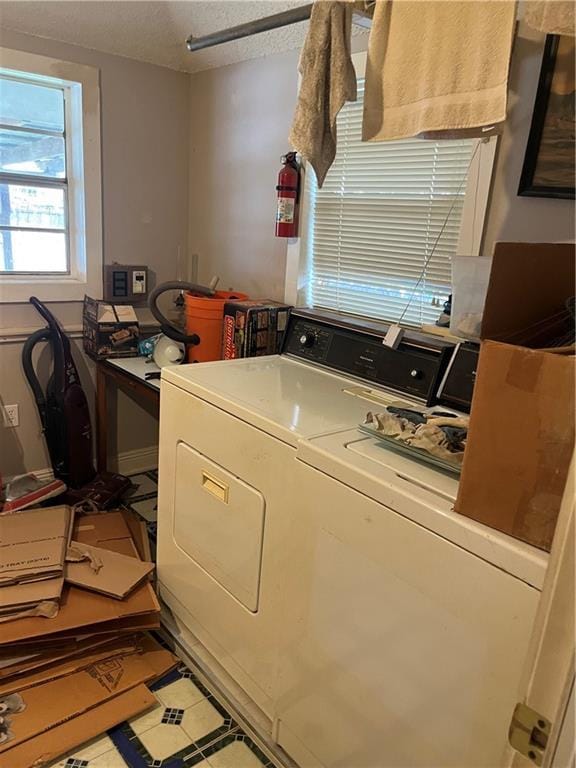 laundry room featuring washer and clothes dryer, laundry area, and a textured ceiling