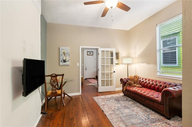 living room featuring hardwood / wood-style flooring, french doors, baseboards, and ceiling fan