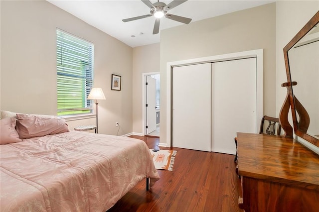 bedroom featuring ceiling fan, a closet, baseboards, and wood finished floors