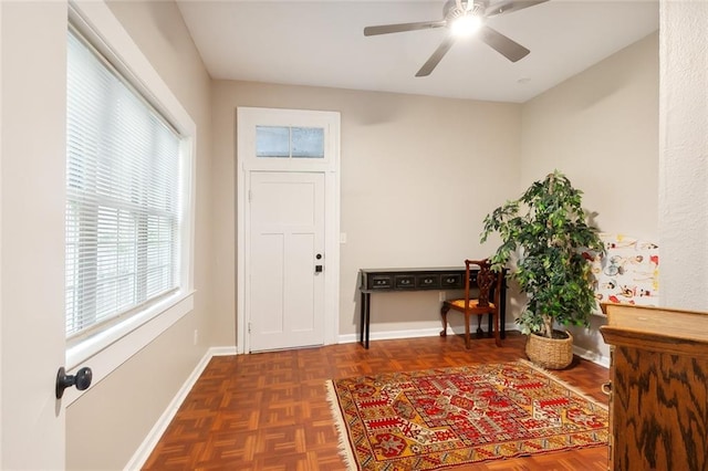 entryway featuring a ceiling fan and baseboards