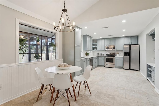 dining room featuring visible vents, recessed lighting, an inviting chandelier, wainscoting, and vaulted ceiling