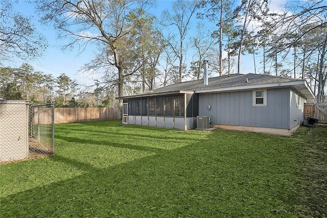 view of yard with cooling unit, a fenced backyard, and a sunroom