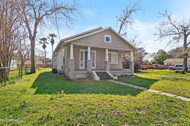 bungalow-style house with a porch, fence, and a front yard