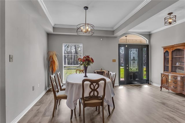 31501 River Pines Dr, Springfield, LA 70462 - dining space with crown molding, baseboards, wood finished floors, and a notable chandelier