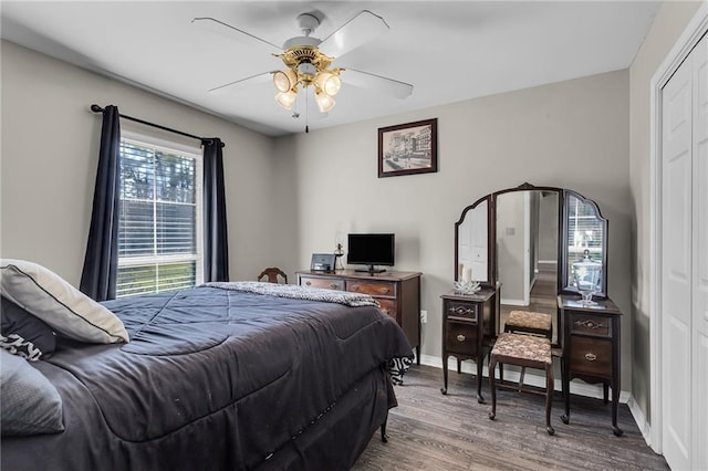 31501 River Pines Dr, Springfield, LA 70462 - bedroom with baseboards, ceiling fan, wood finished floors, and a closet